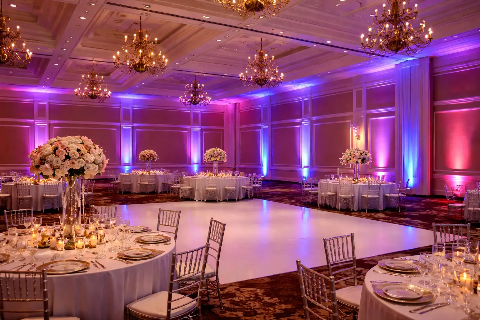 Elegant ballroom with colorful uplighting.